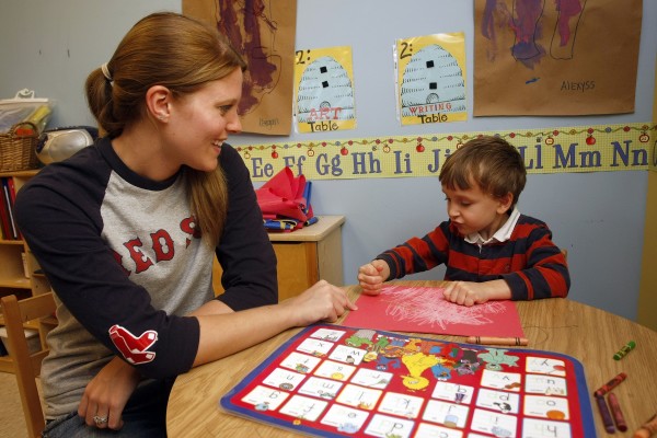 student teaching a child in daycare
