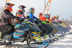 snomobile racers at start line
