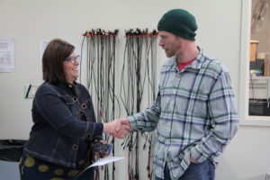 jeremy cole shaking hands with president larson