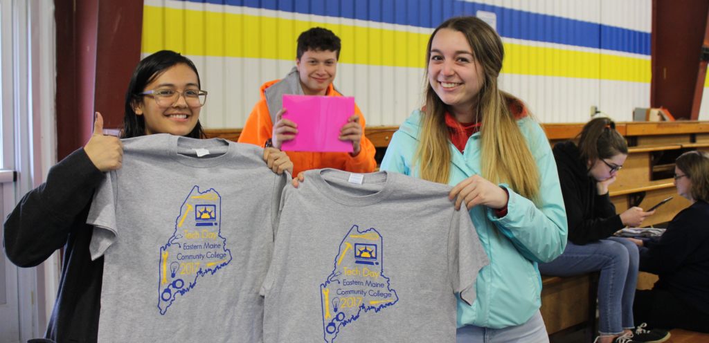 new students holding tshirts