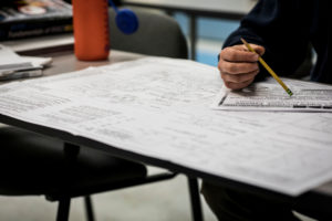 eastern maine community college student writing in class